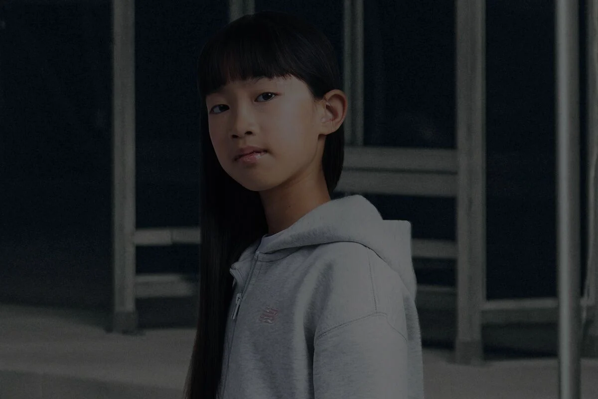 Girl wearing grey New Balance hoodie