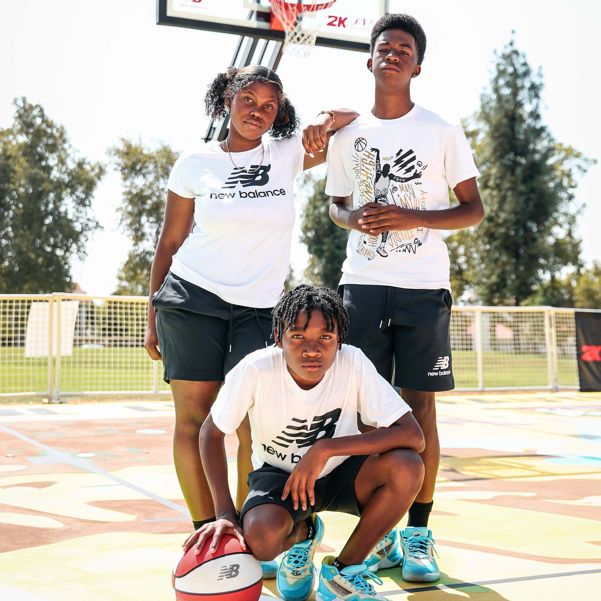 Kids posed on outdoor basketball court in New Balance gear
