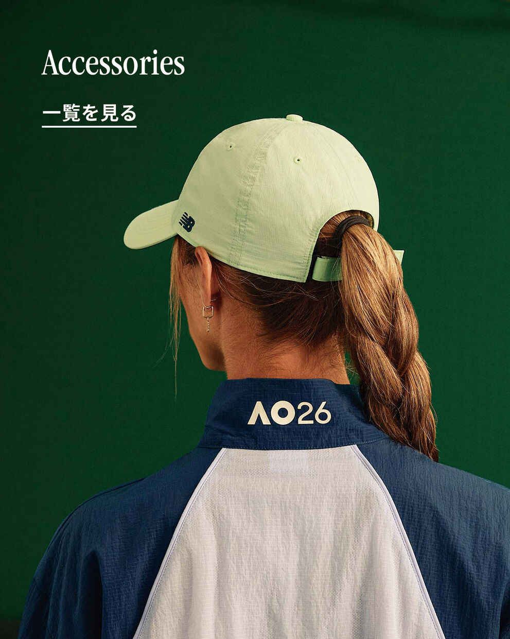A person looking away from the camera, the Australian Open logo is displayed on the back of their jacket.