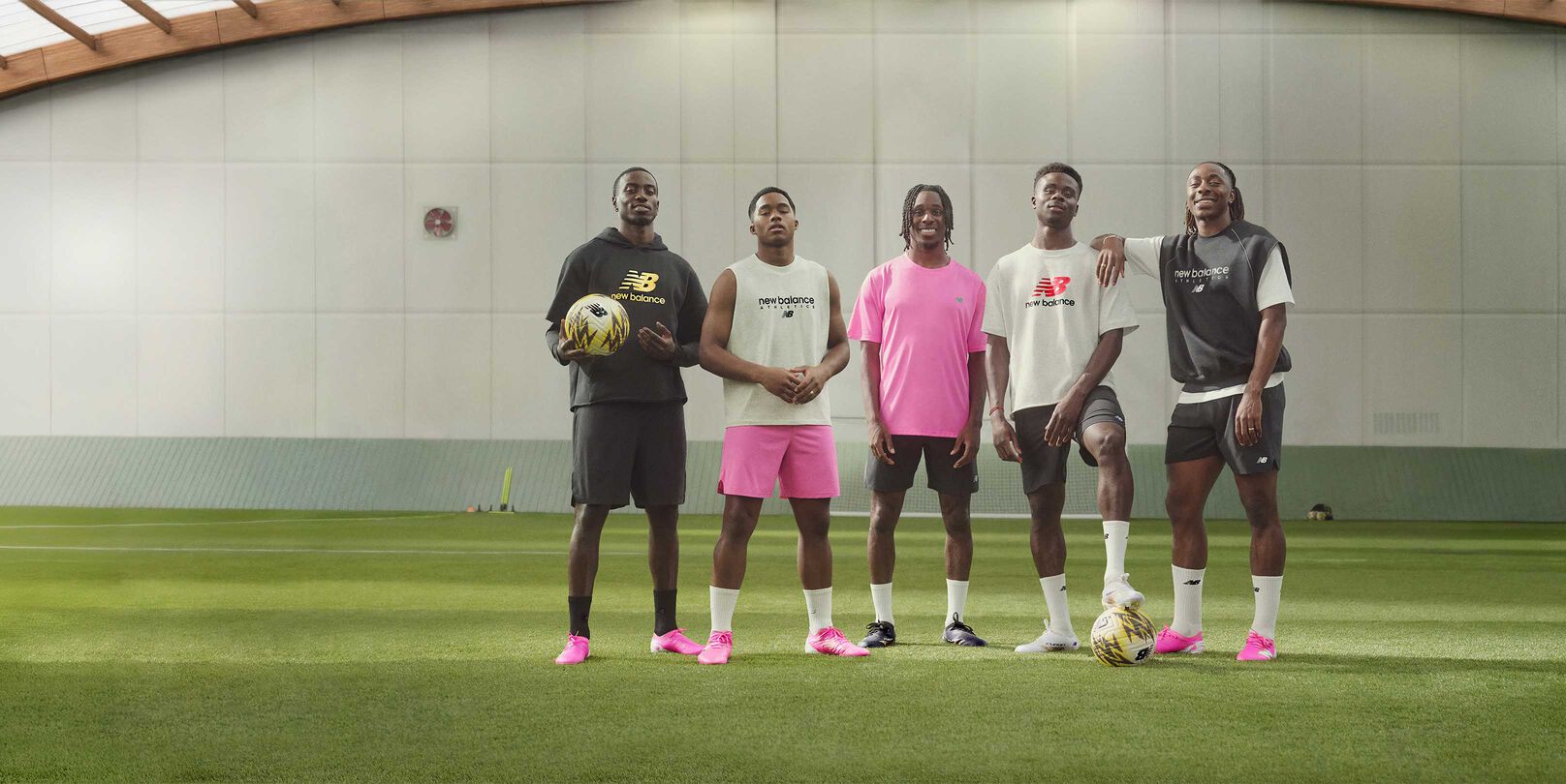 A group of soccer players standing on a soccer field.